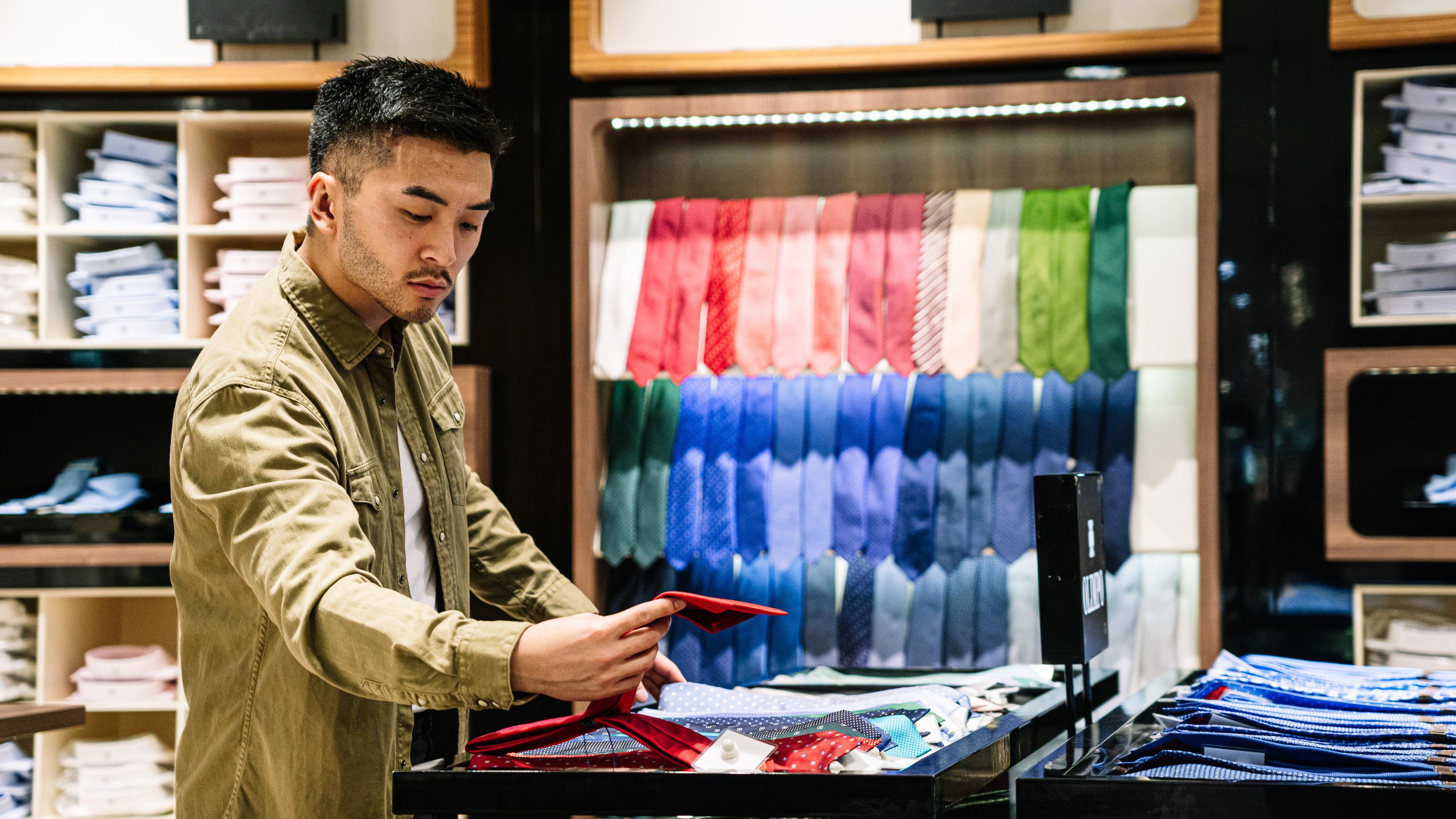 Asian man is selecting dresses