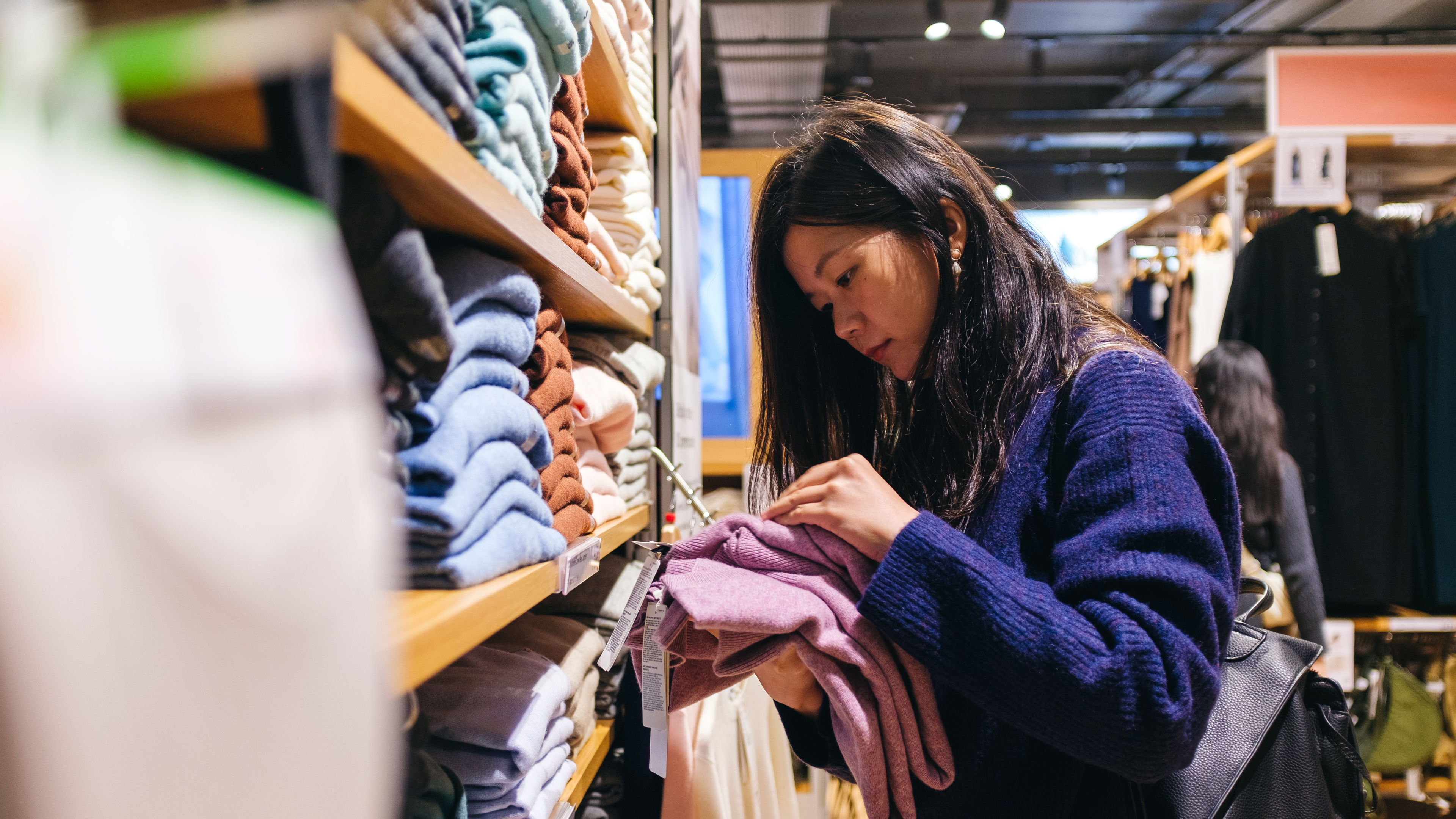 A cheerful woman choosing clothes
