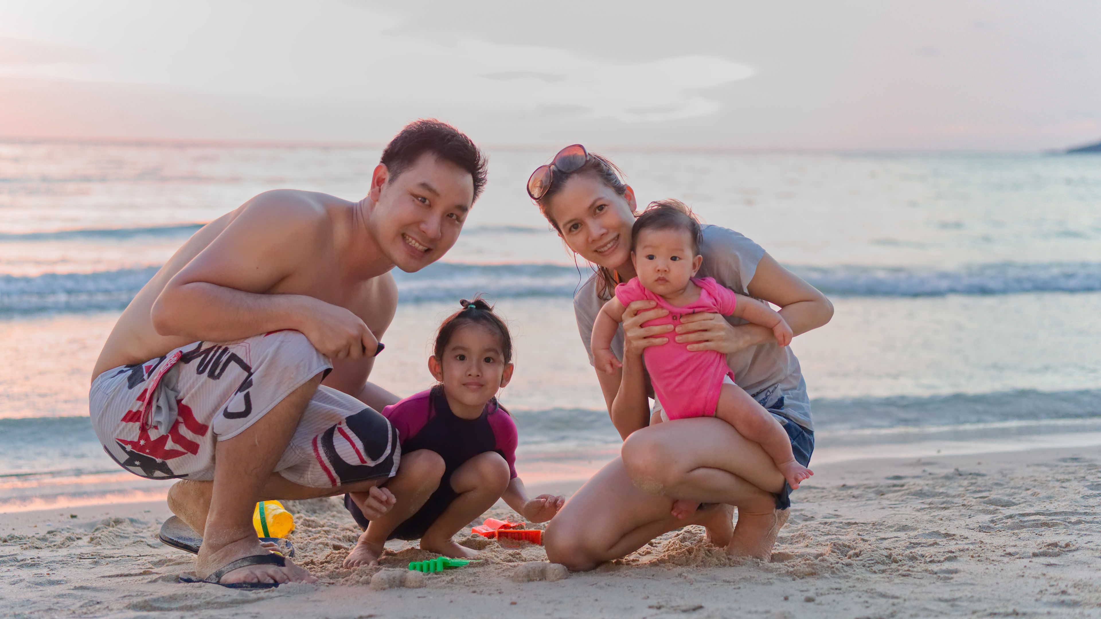 A family of four enjoying their vacation on a beach. 