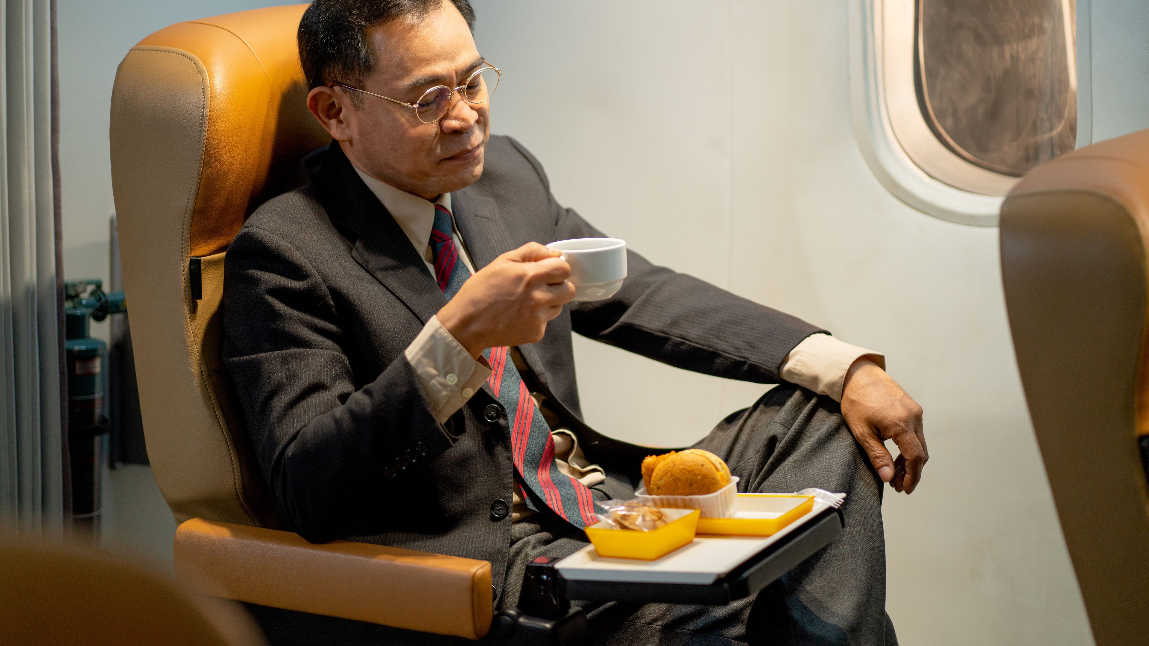 A man having food in a flight 