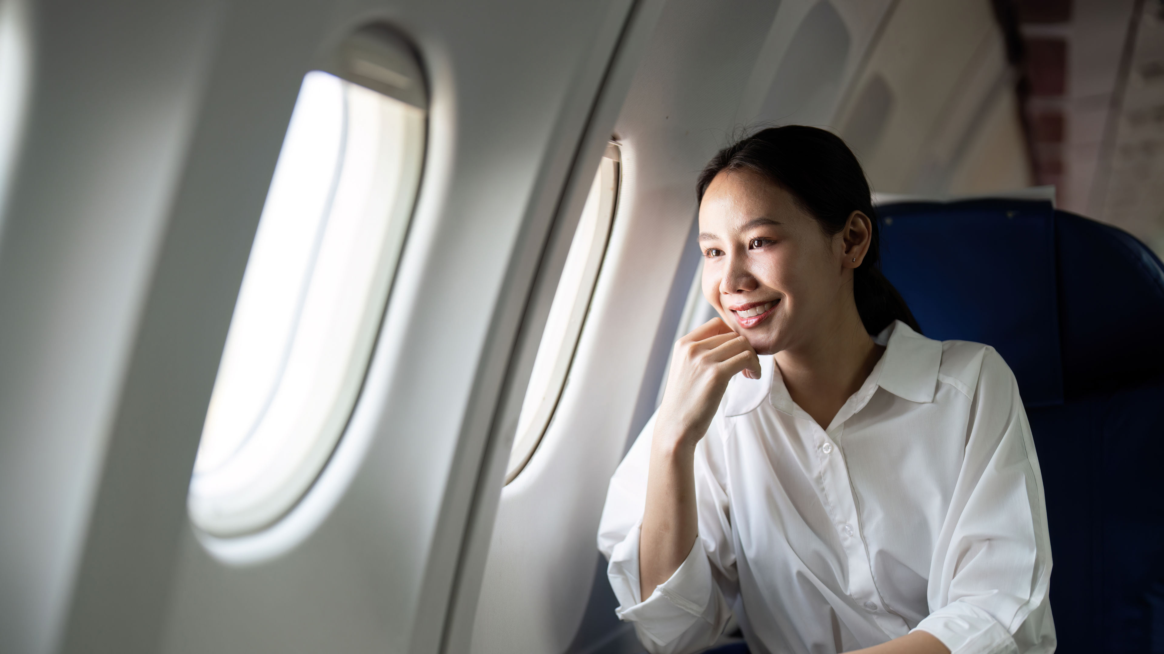 A woman happily enjoying the flight 