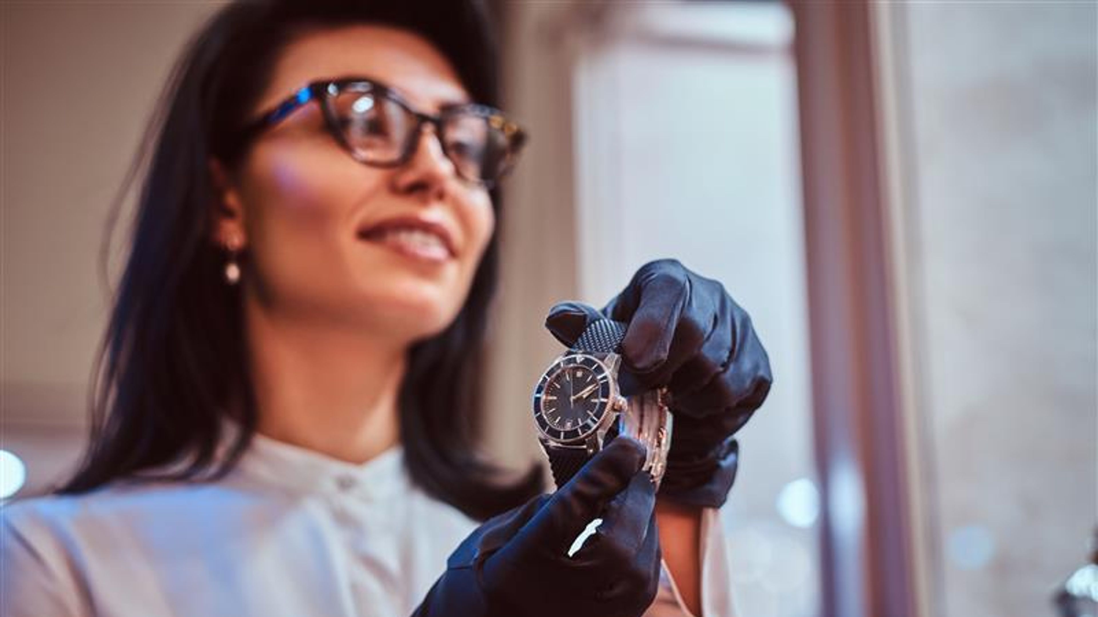 A woman holding a luxury watch 