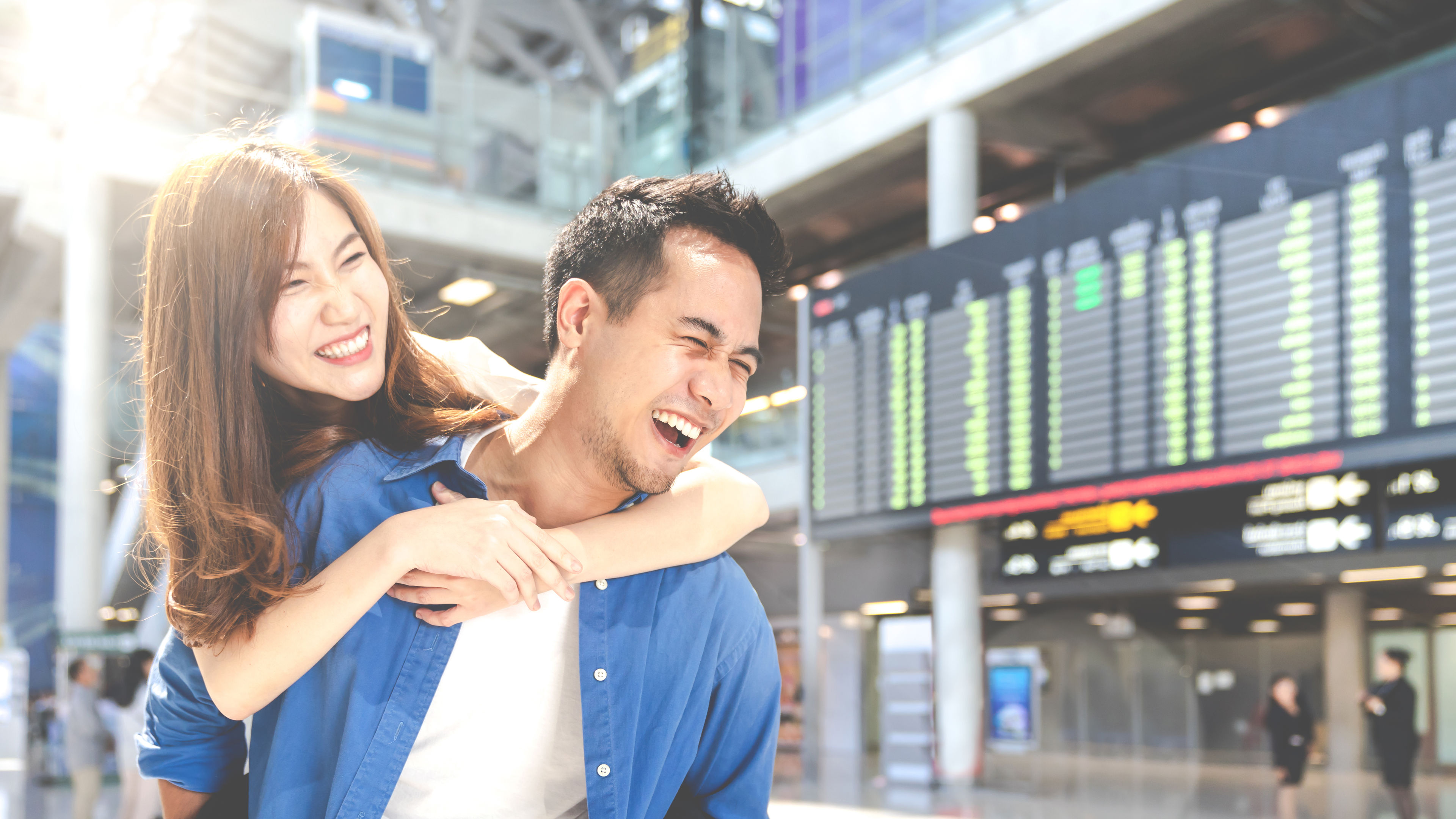 A young couple having fun at the aiport