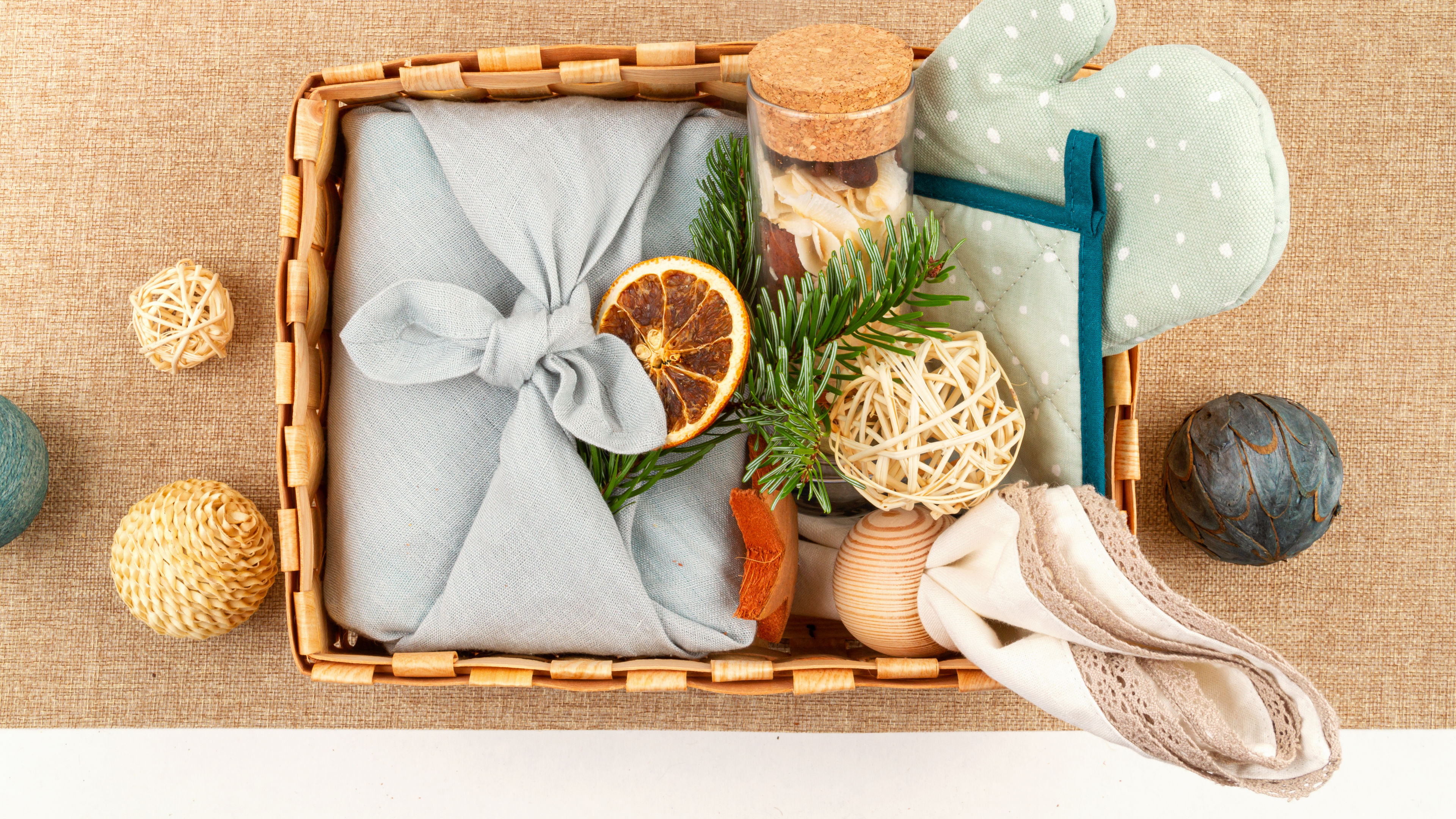 A sweet baby hamper with plush toys, clothes, and accessories in a cozy basket. 