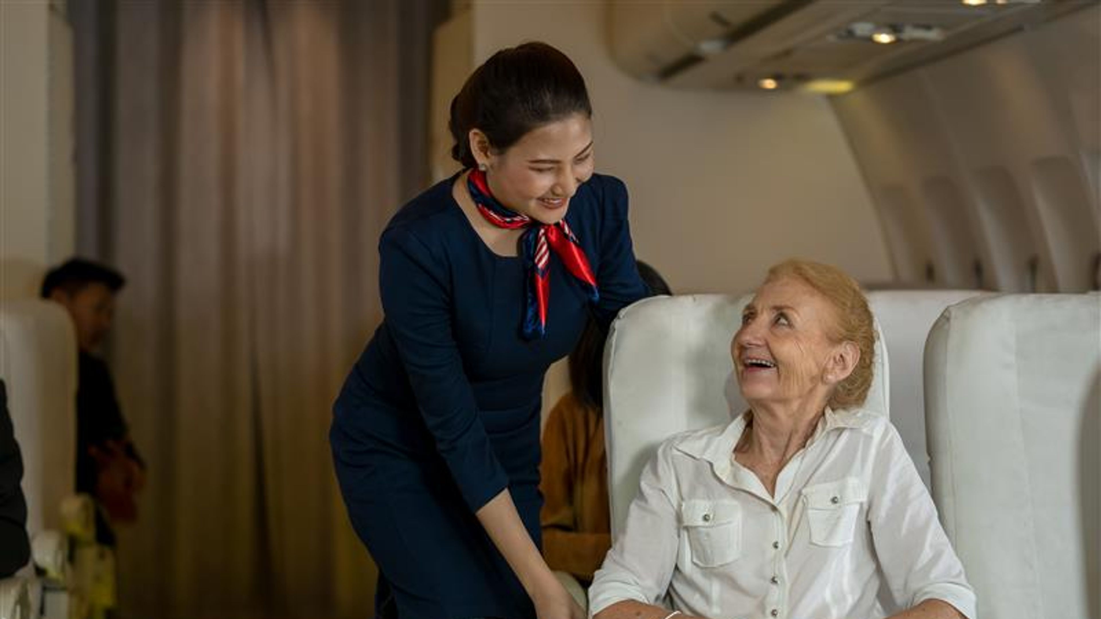 An air hostess helping a passenger 