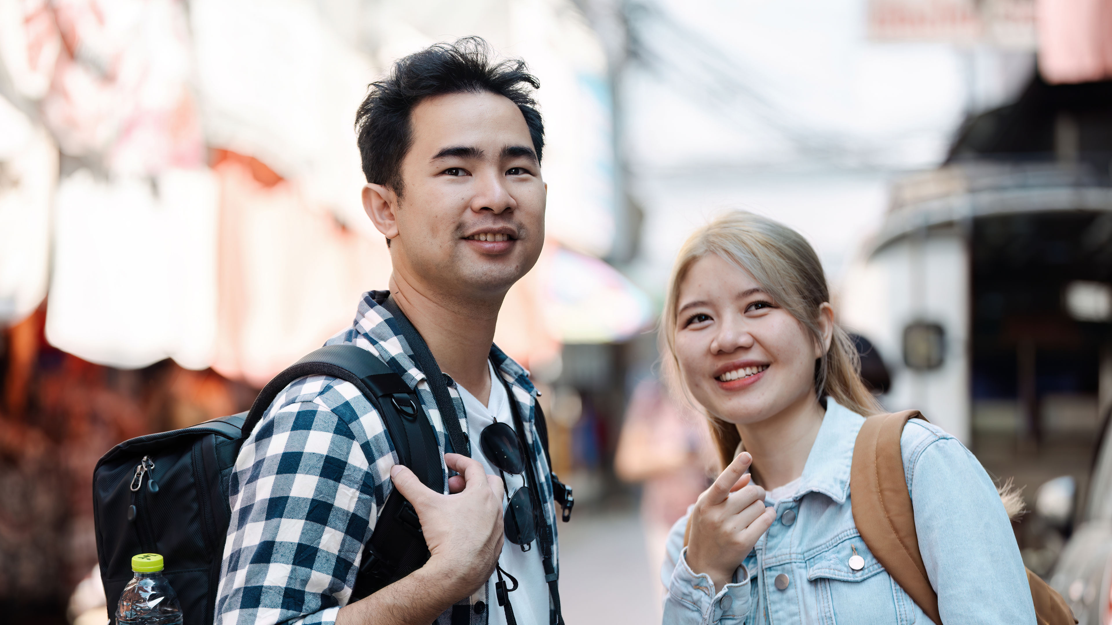 A young couple travelling in a vibrant market in Singapore 