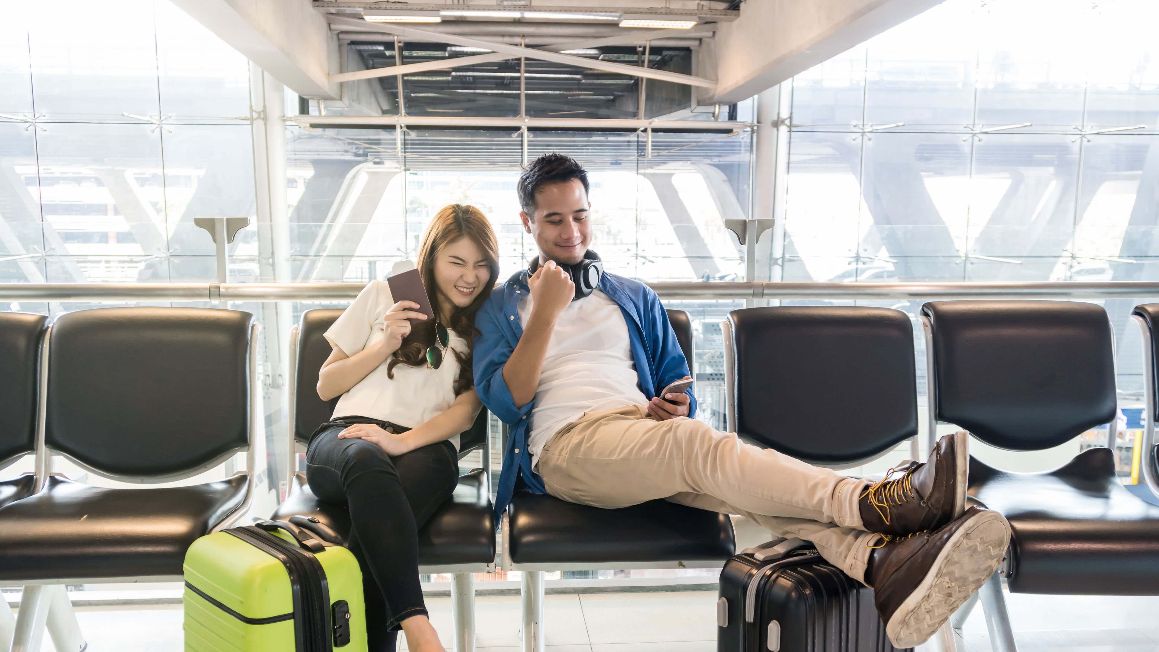 Picture of a couple waiting in airport. 