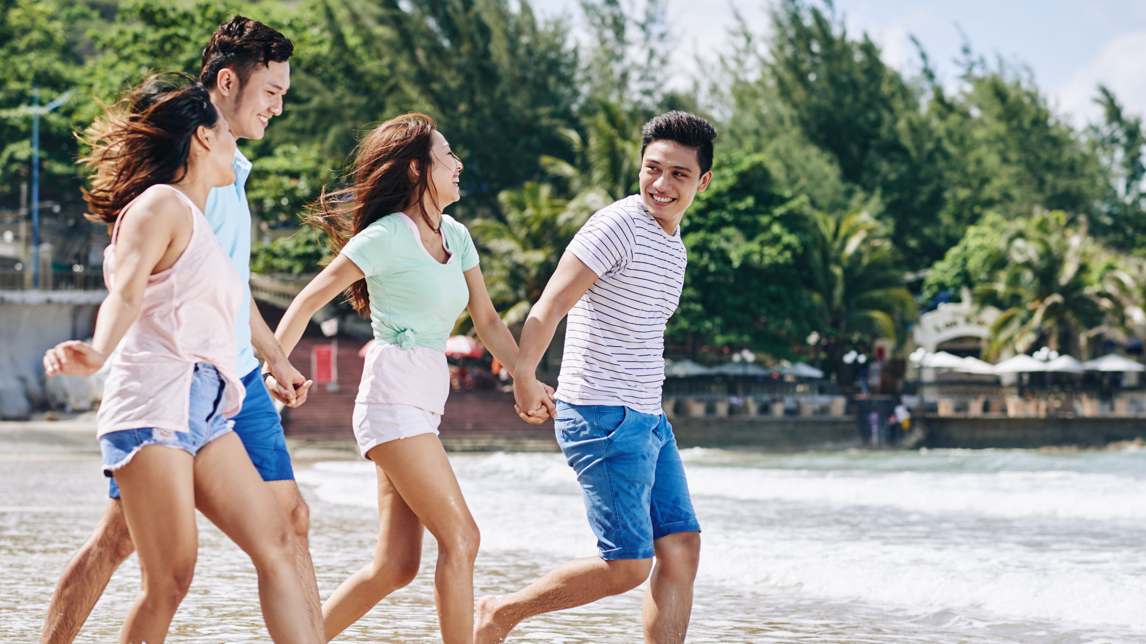 A group of friends enjoying leisurely activities on the beach 