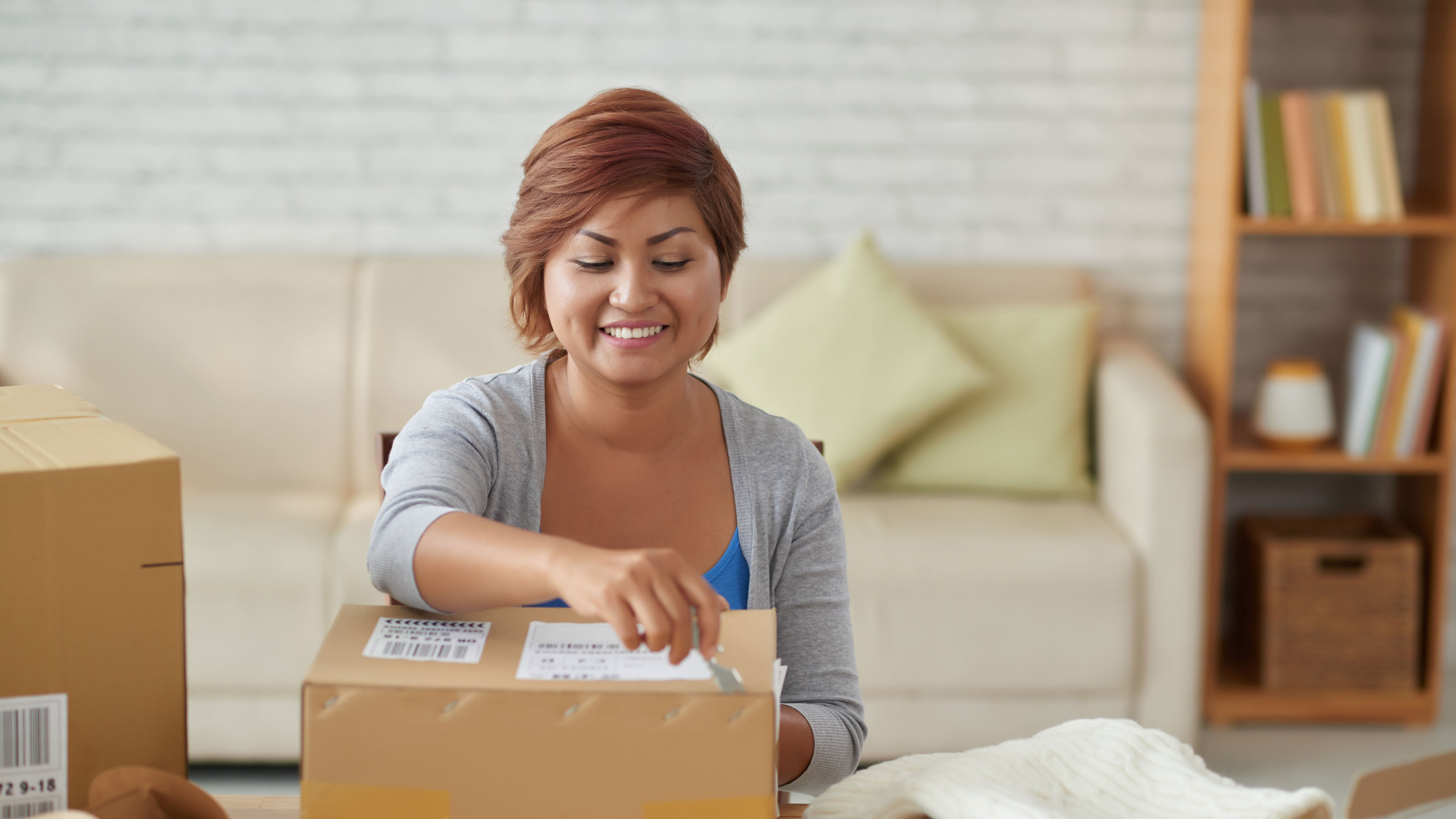 Image of a Woman opening parcels