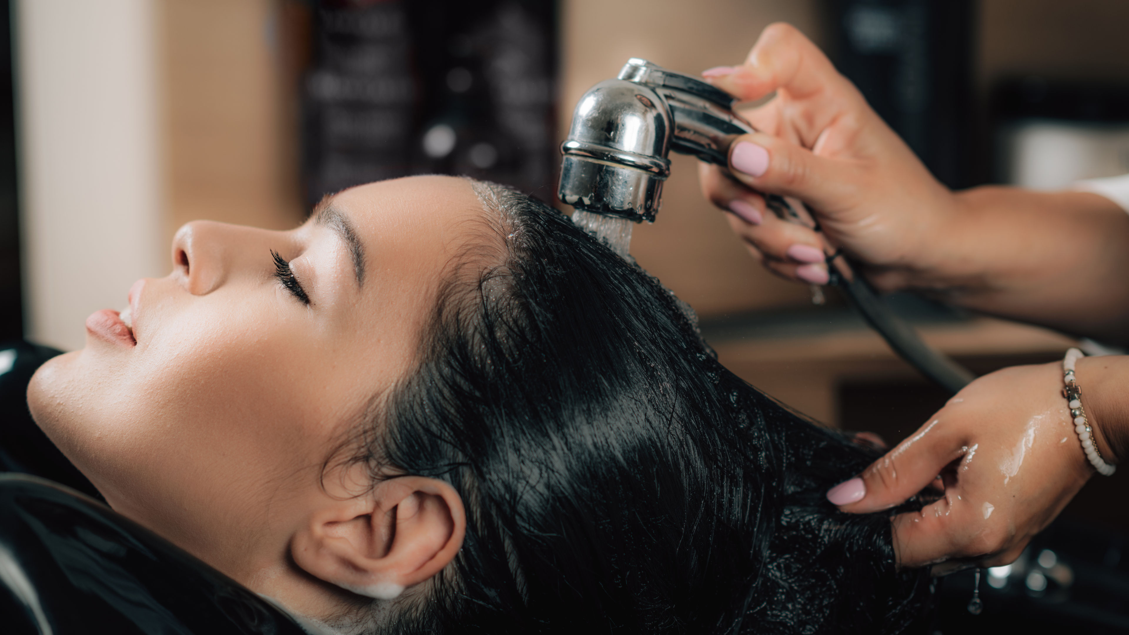 Lady in a salon doing hairwash 