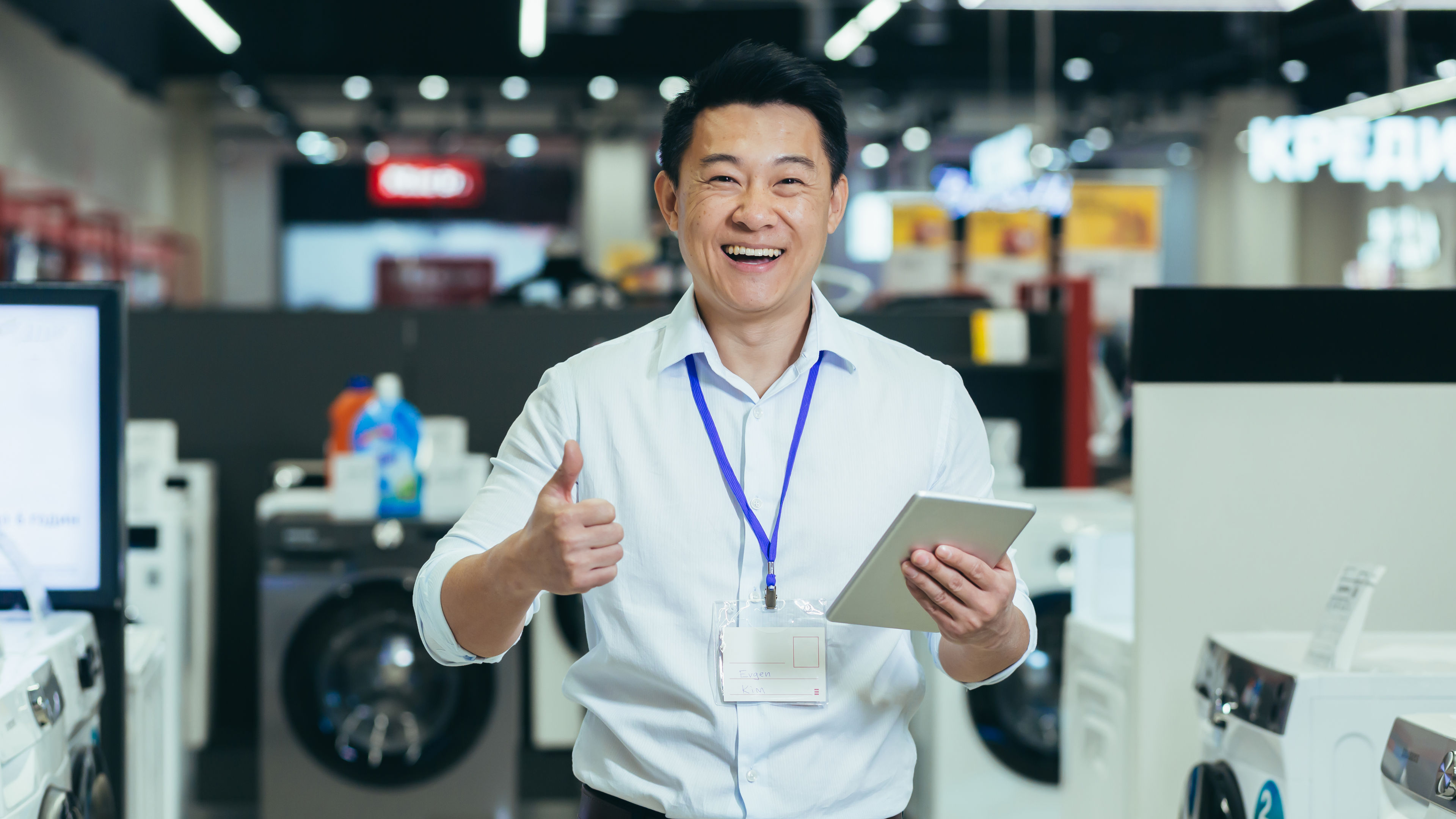 A man explores an electronic store, browsing gadgets and comparing the latest devices. 