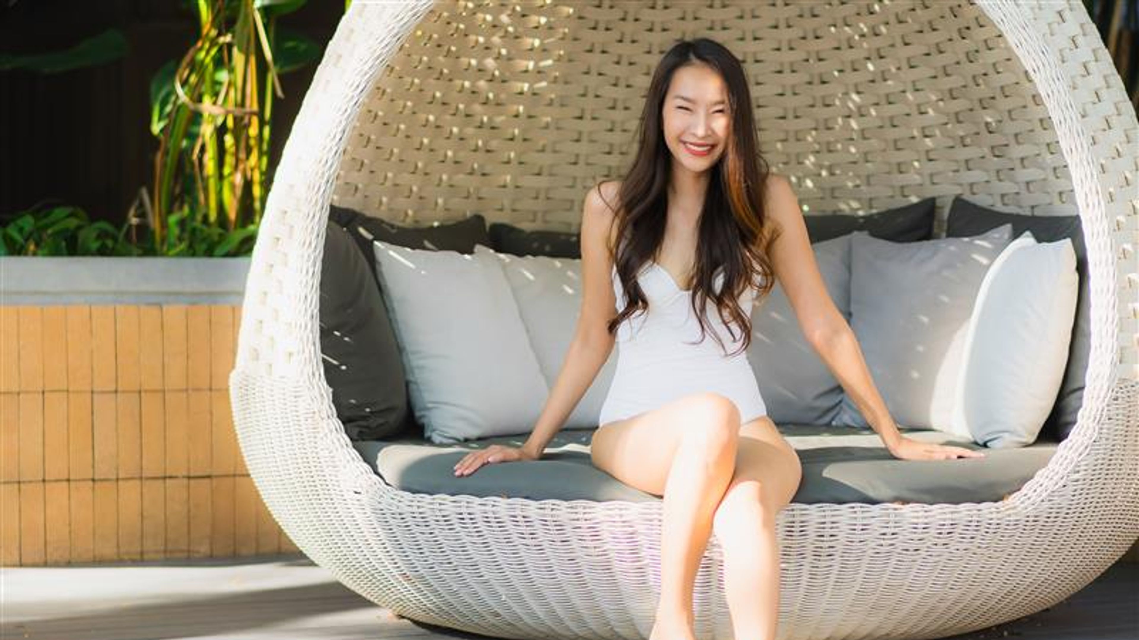 Portrait beautiful young asian woman happy smile and relax around swimming pool in hotel resort for leisure travel and vacation. 