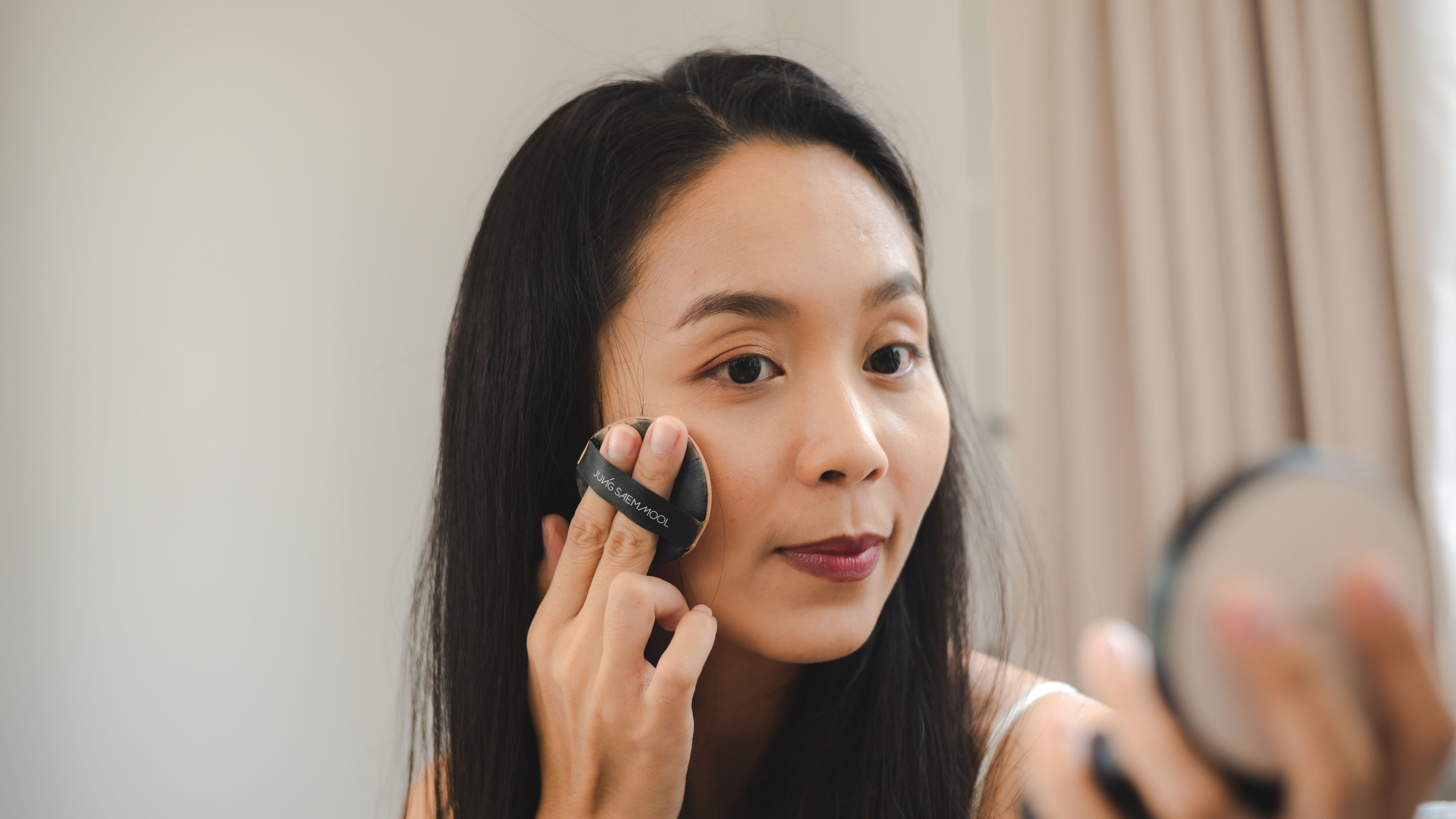 Singapore woman applying make up for a party 