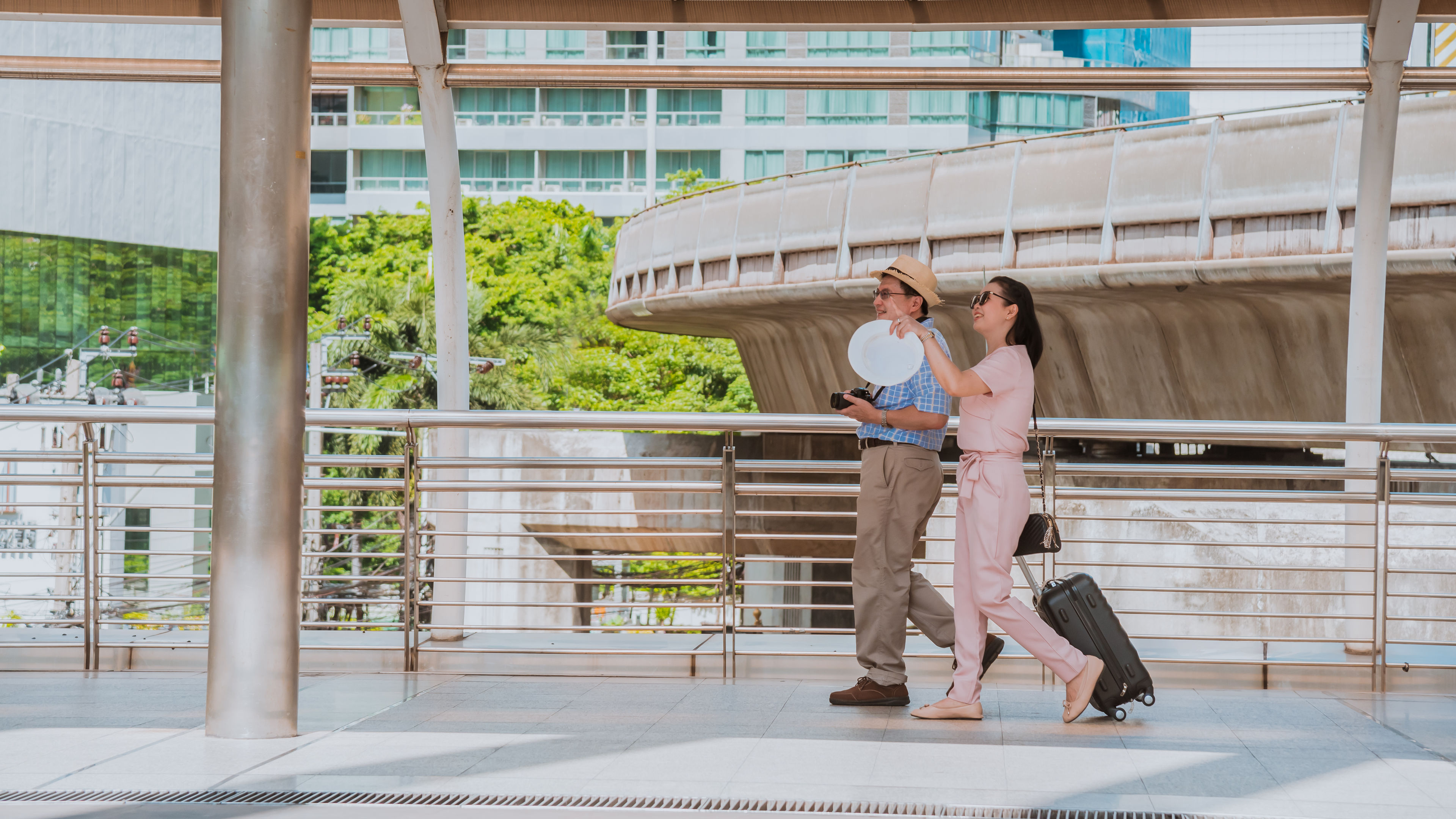 Tourist man and woman walking with luggage 