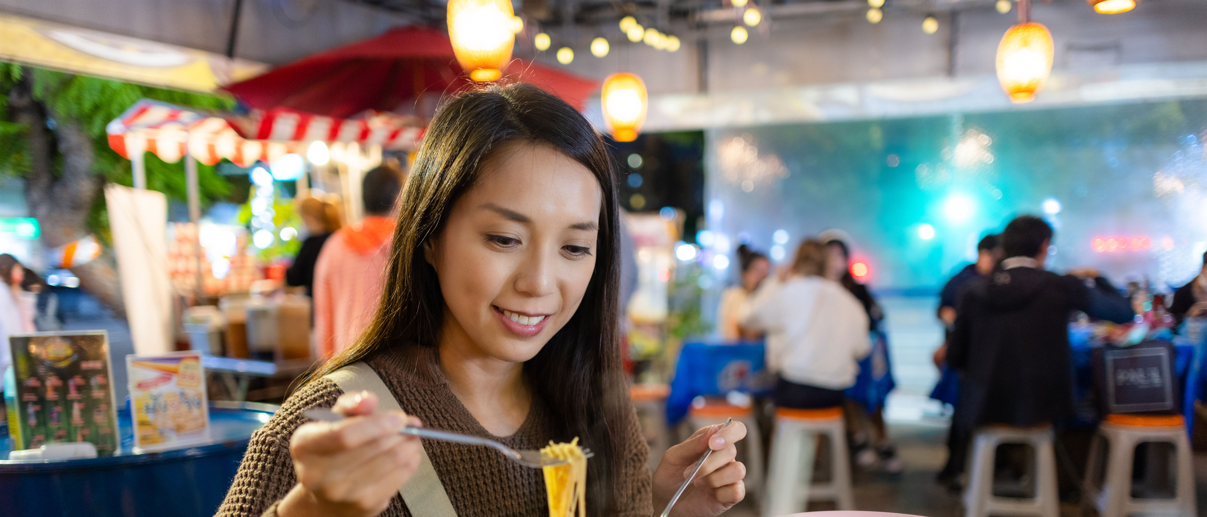 Woman eating noodles