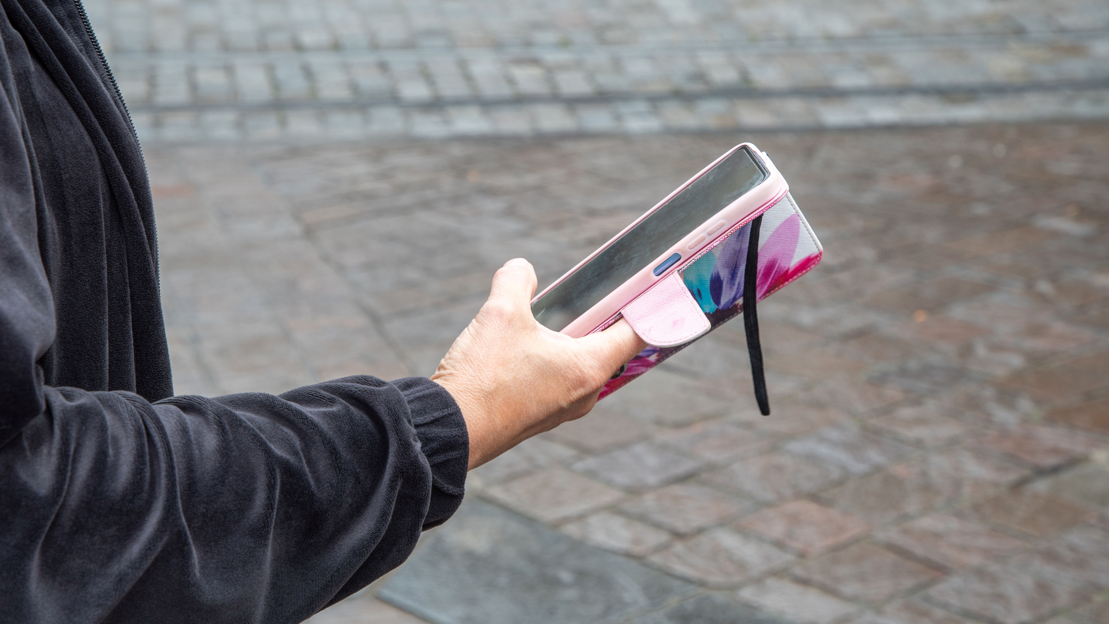 Woman in black blouse uses smartphone 