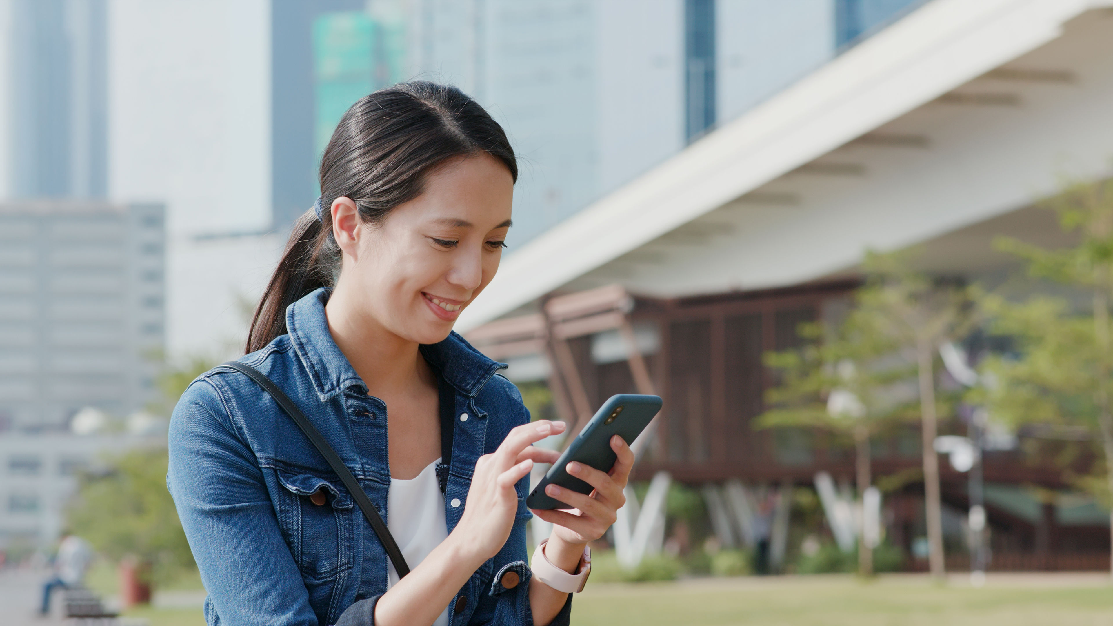 Woman sending text message on mobile phone 