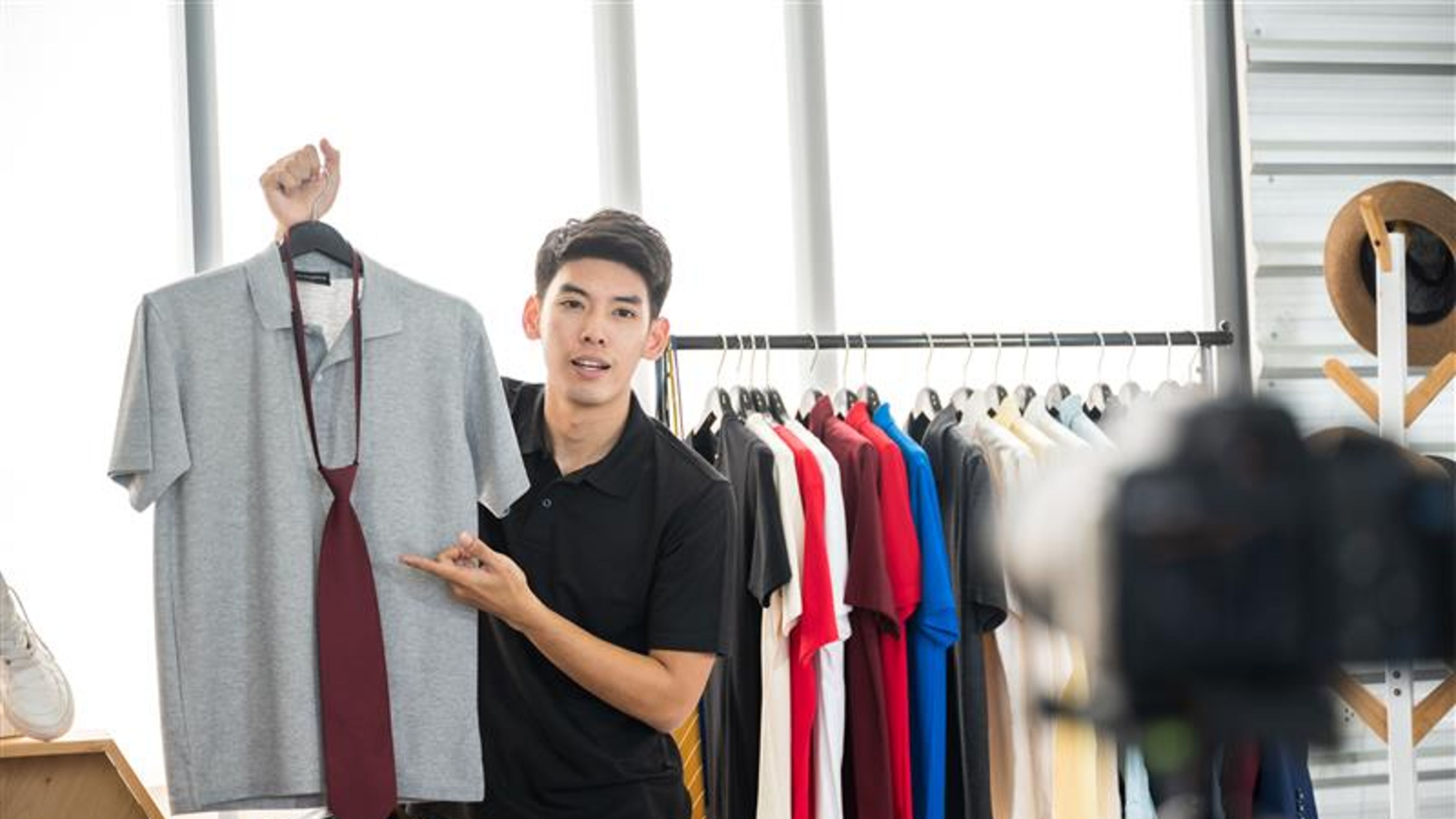 Young men are recording videos to sell shirts online