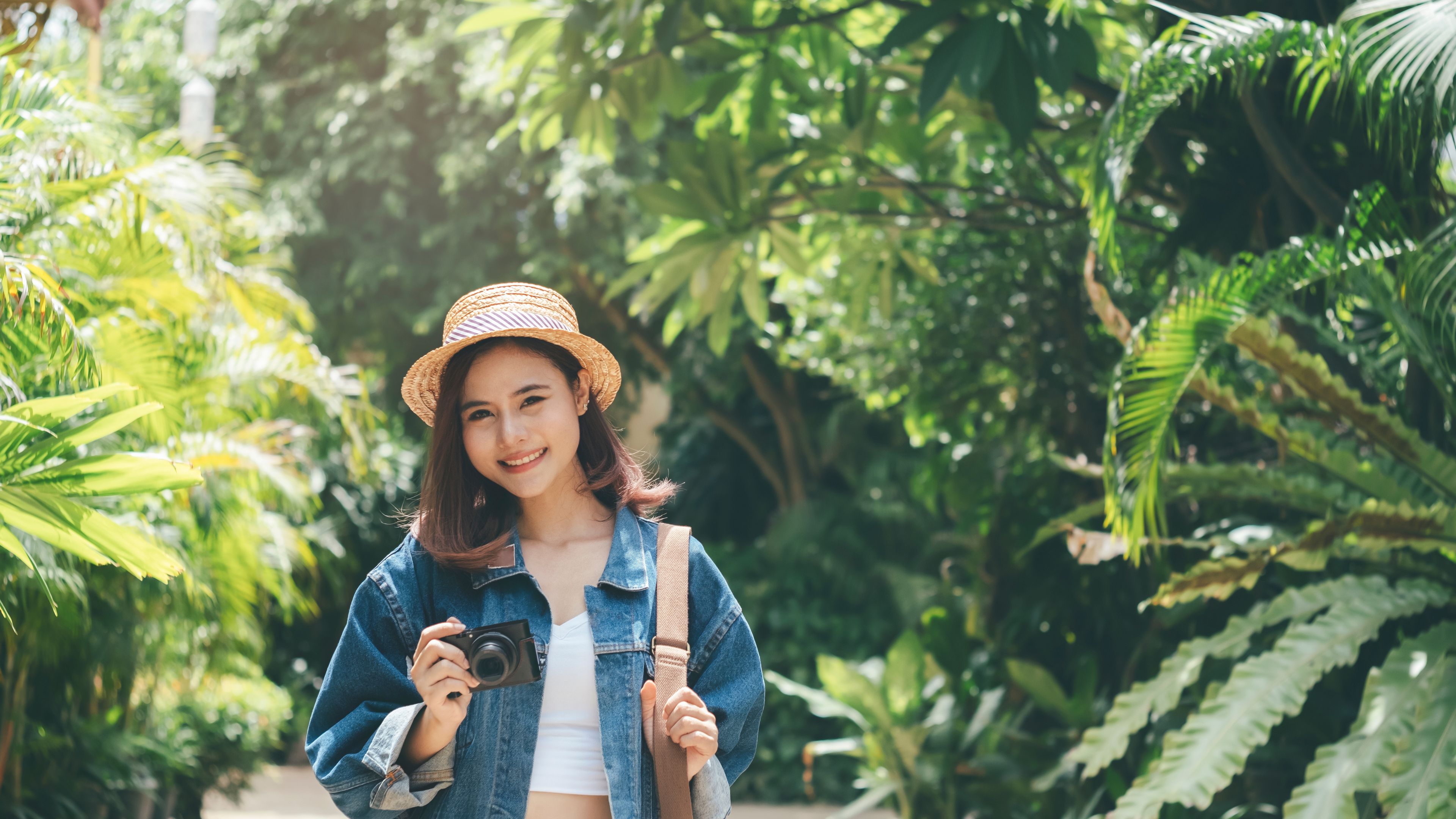 Young traveller exploring with a camera in a garden in Singapore 