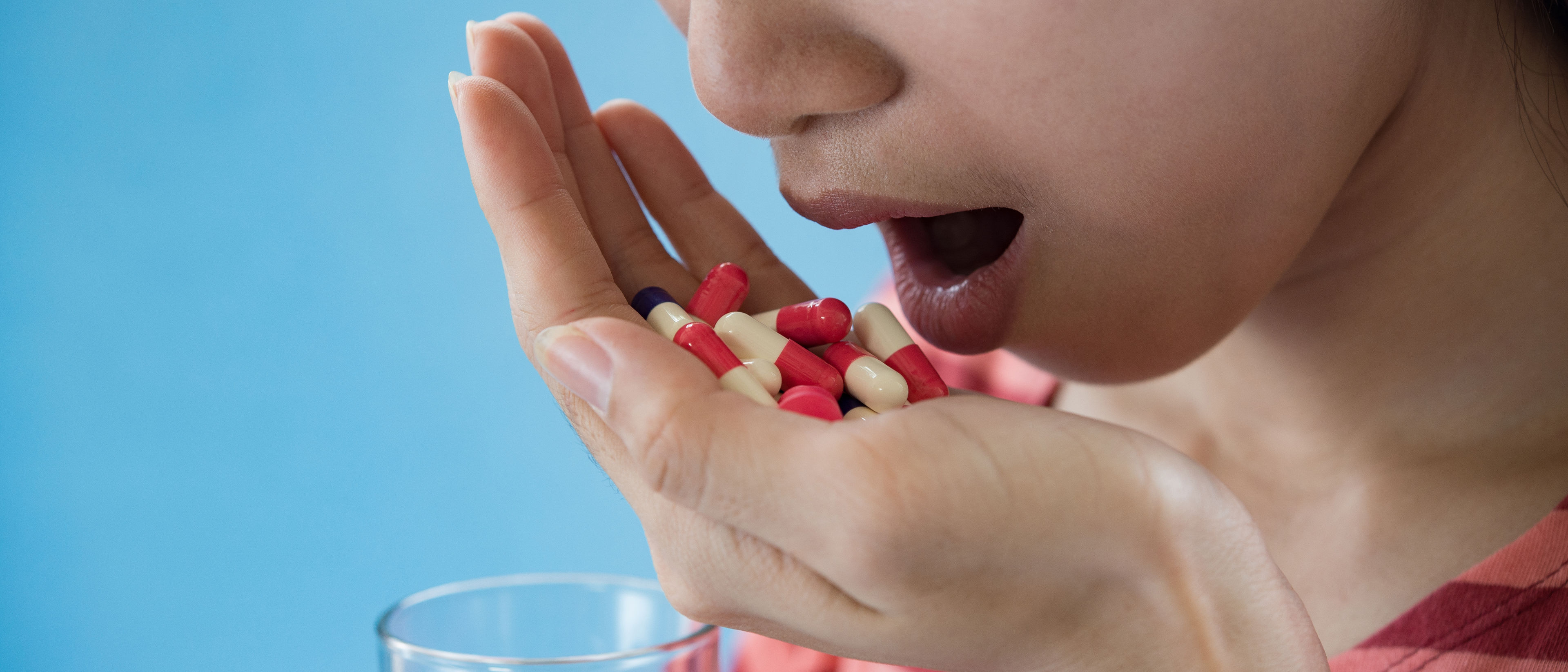 Young woman taking medicine